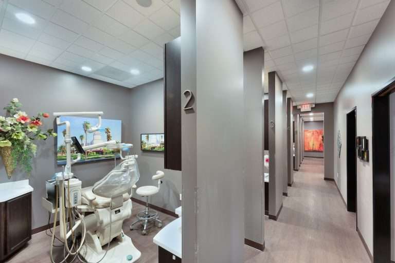Operatory and hallway view at Sacramento Dentistry Group showing private enclosed treatment rooms