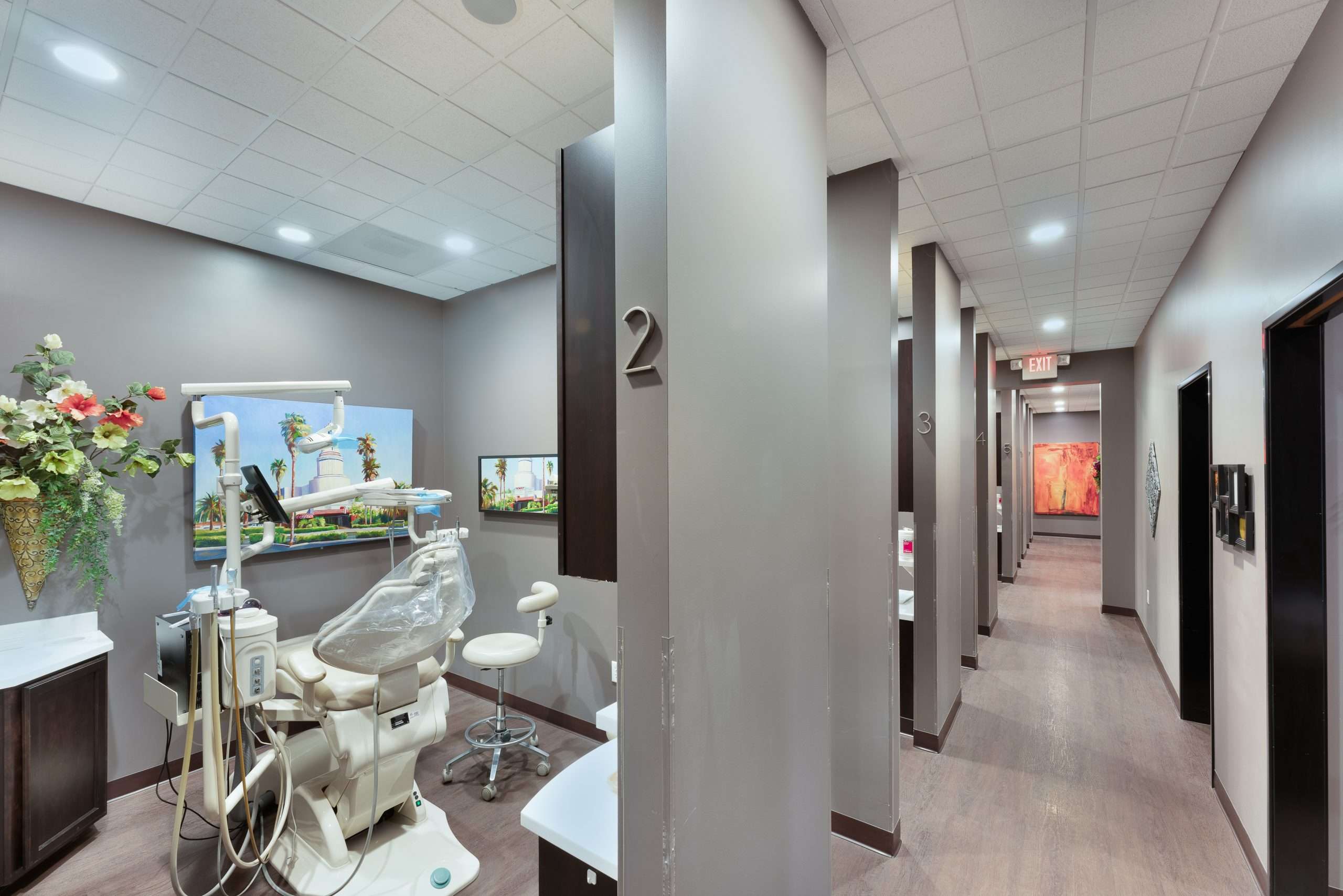 Operatory at Sacramento Dentistry Group with overhead ceiling art visible down the hallway, creating a calm environment for children
